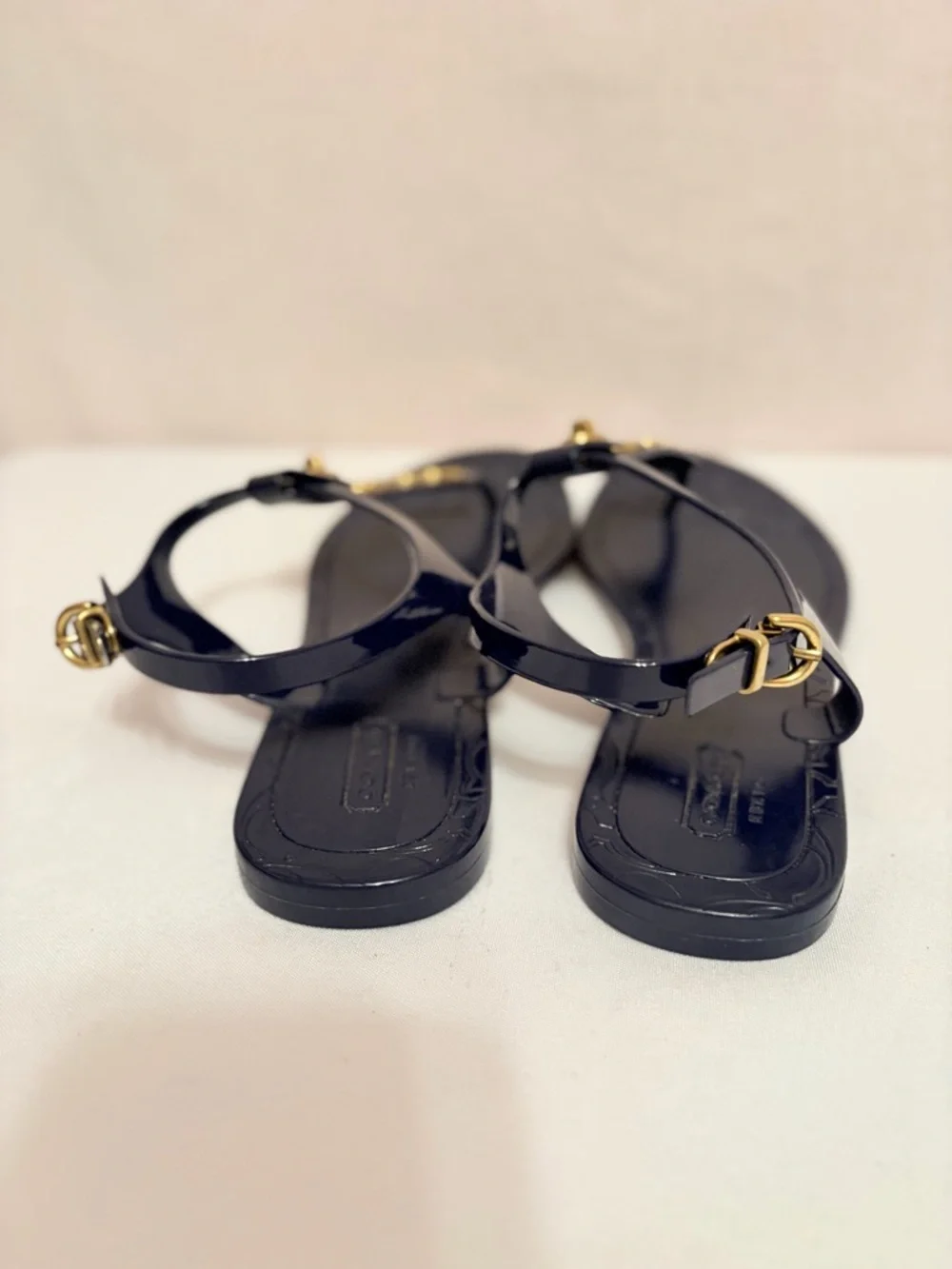 Coach Phila jelly thong sandals in navy blue/gold turnlock and O-ring details